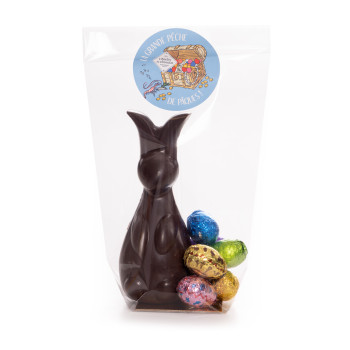 Lapin en chocolat de Pâques et ses petits oeufs enveloppés